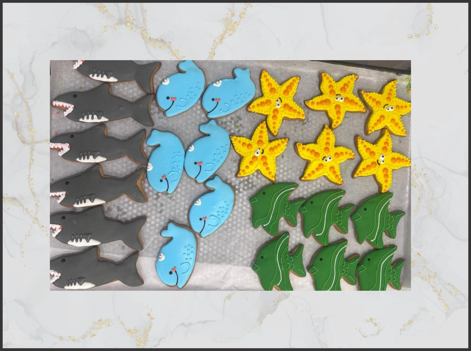 Decorative cookies shaped like sharks, dolphins, and fish on macau bakery cookies