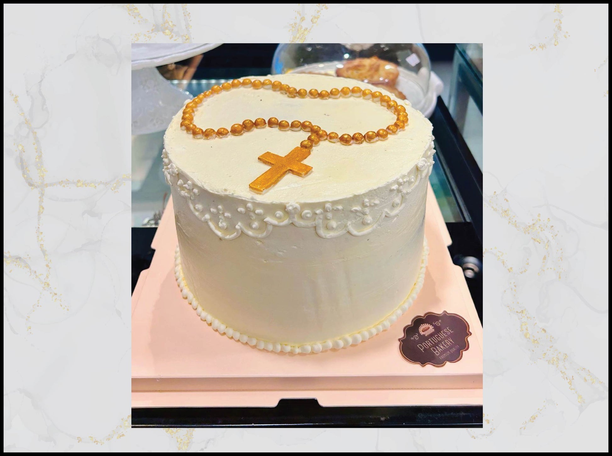 White cake with rosary beads and cross on a pink stand christening cake macau