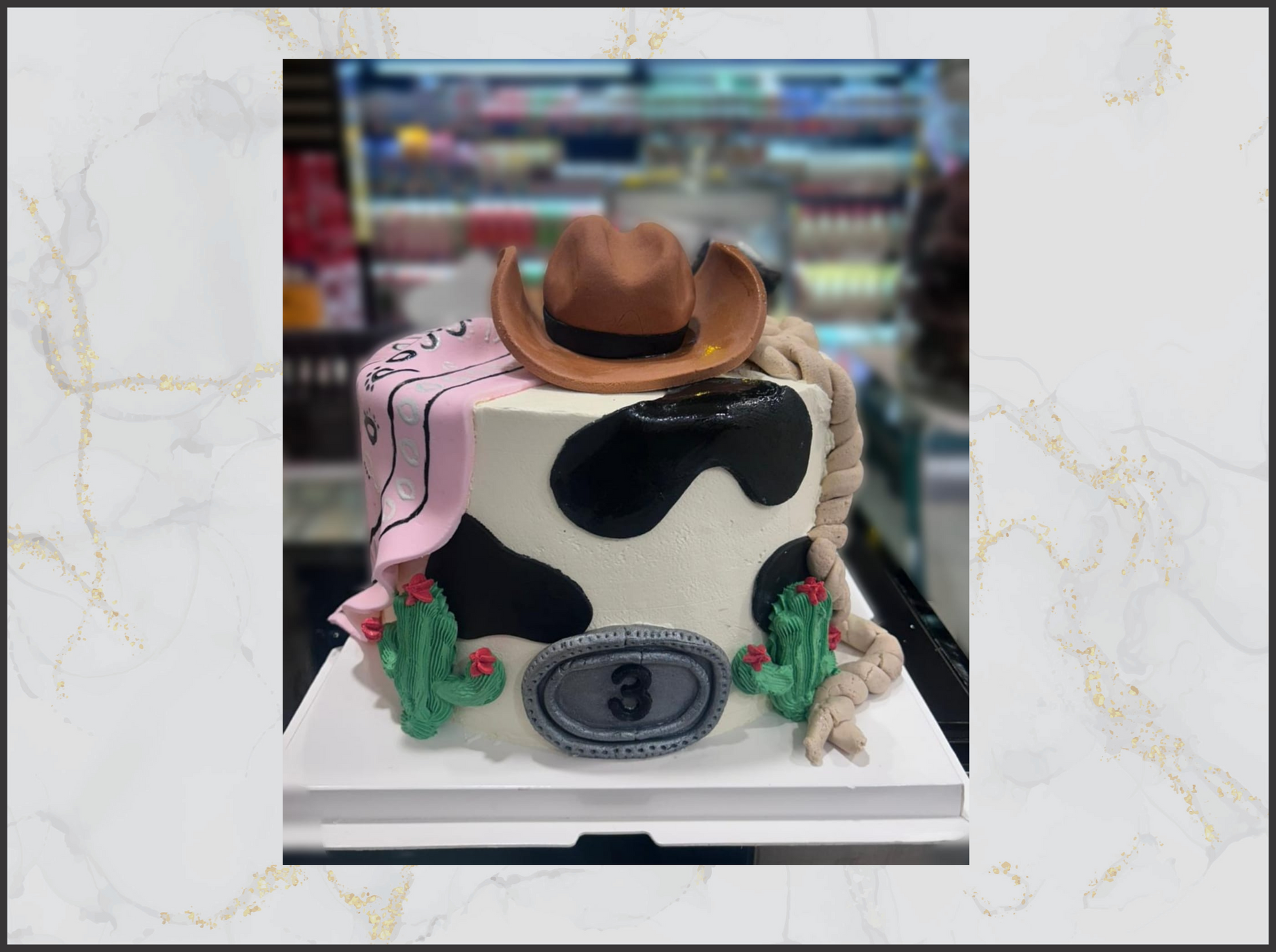 Cowboy-themed birthday cake with a cow print, cowboy hat macau cake