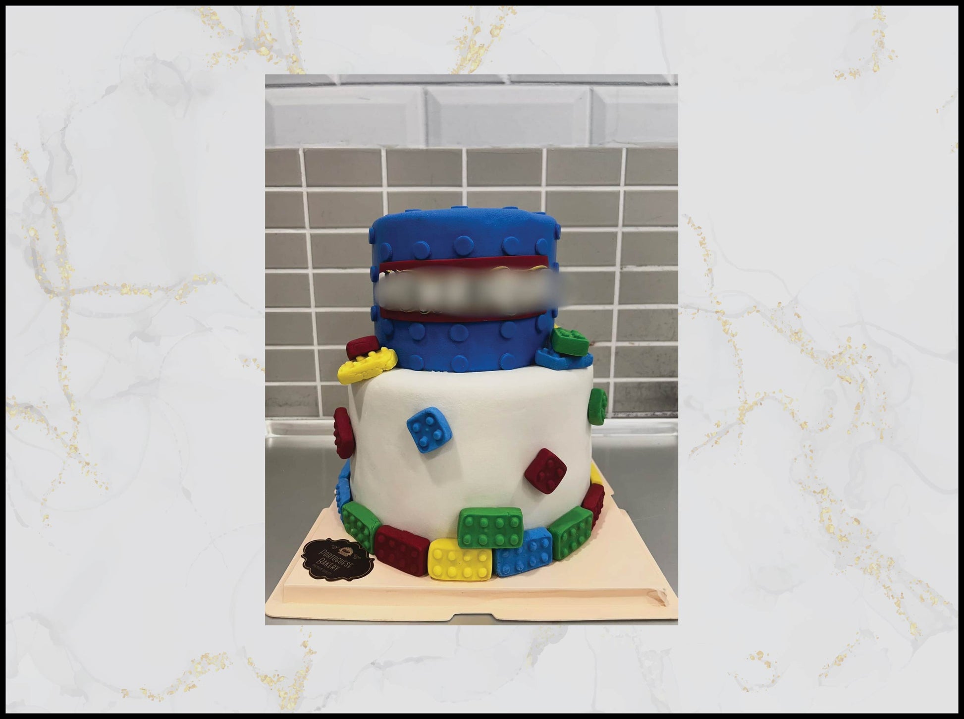 Two-tiered cake decorated like a snowman with colorful lego-style blocks macau cake