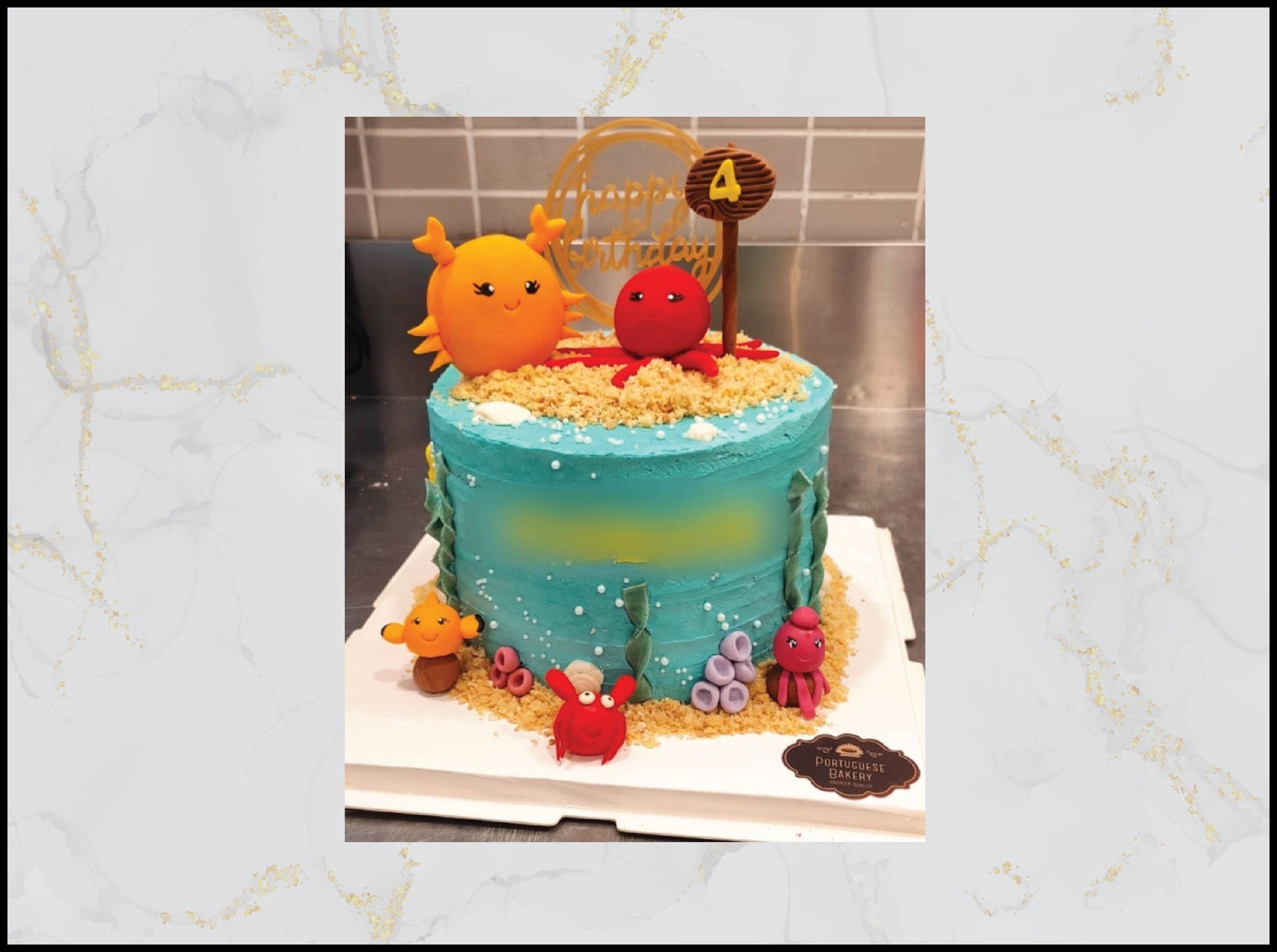 Cake with ocean-themed decorations including fish figures and a number 4 macau bakery cake