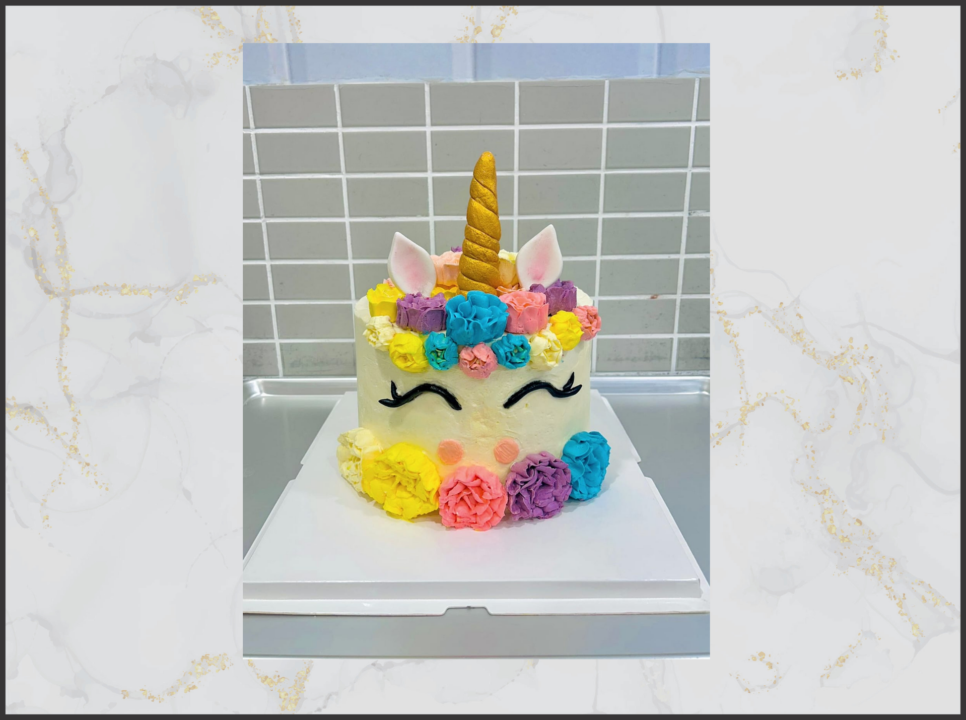 Unicorn cake with colorful flowers and a gold horn macau cake