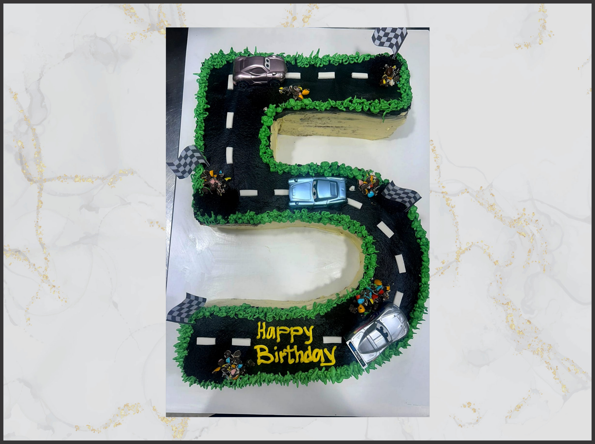 Cake shaped like the number '5' with a road and car decorations in macau